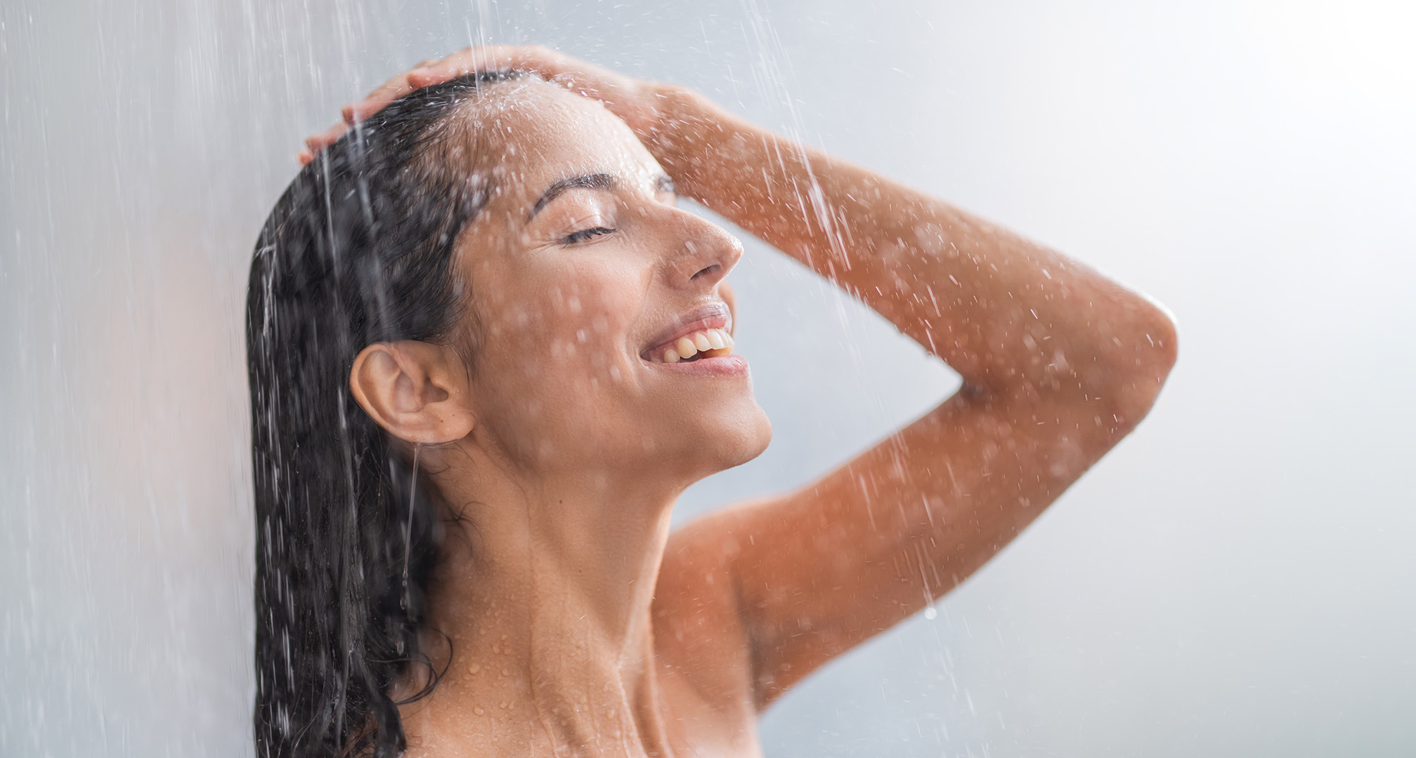 person's face under showerhead