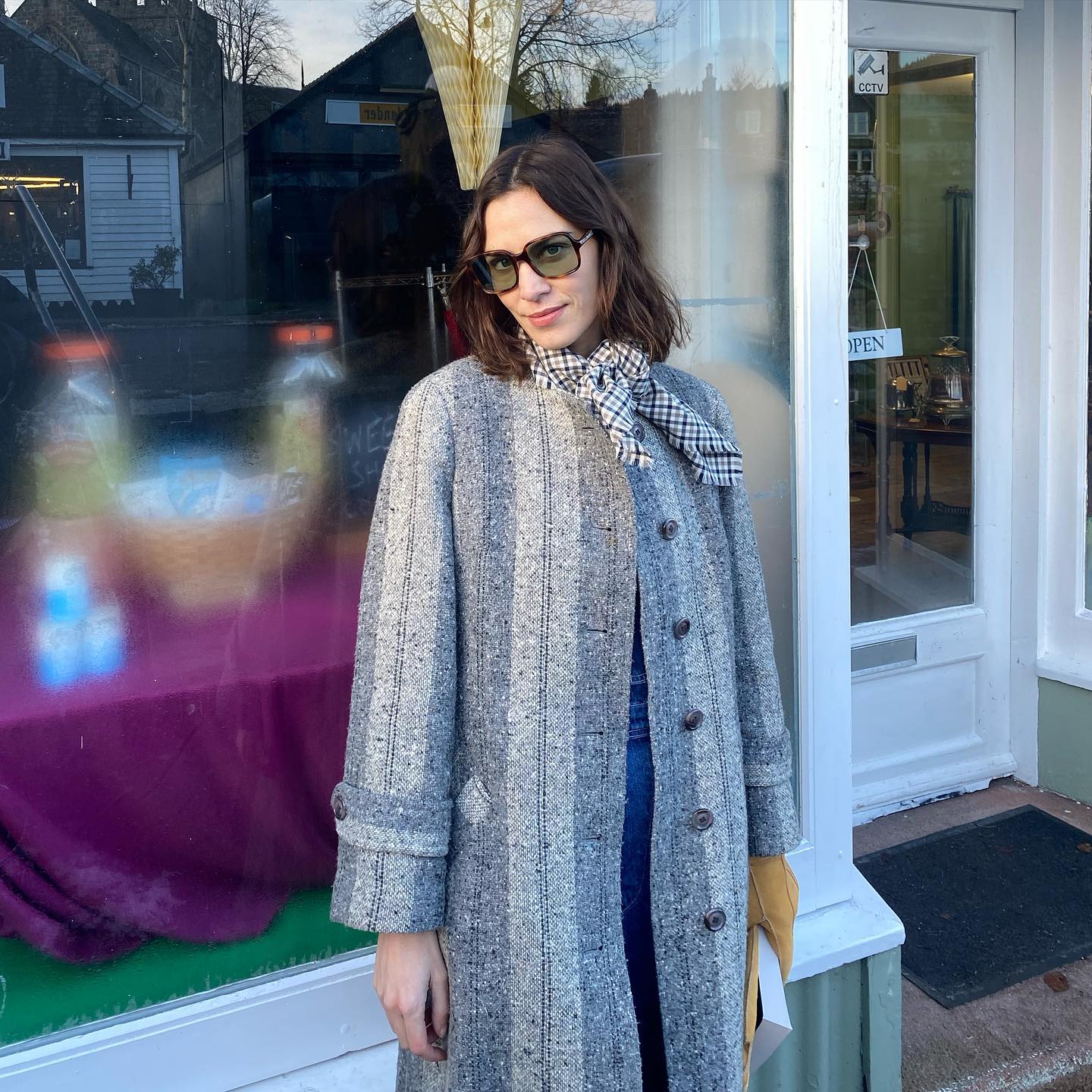 alexa chung wearing blue coat and '70s style sunglasses