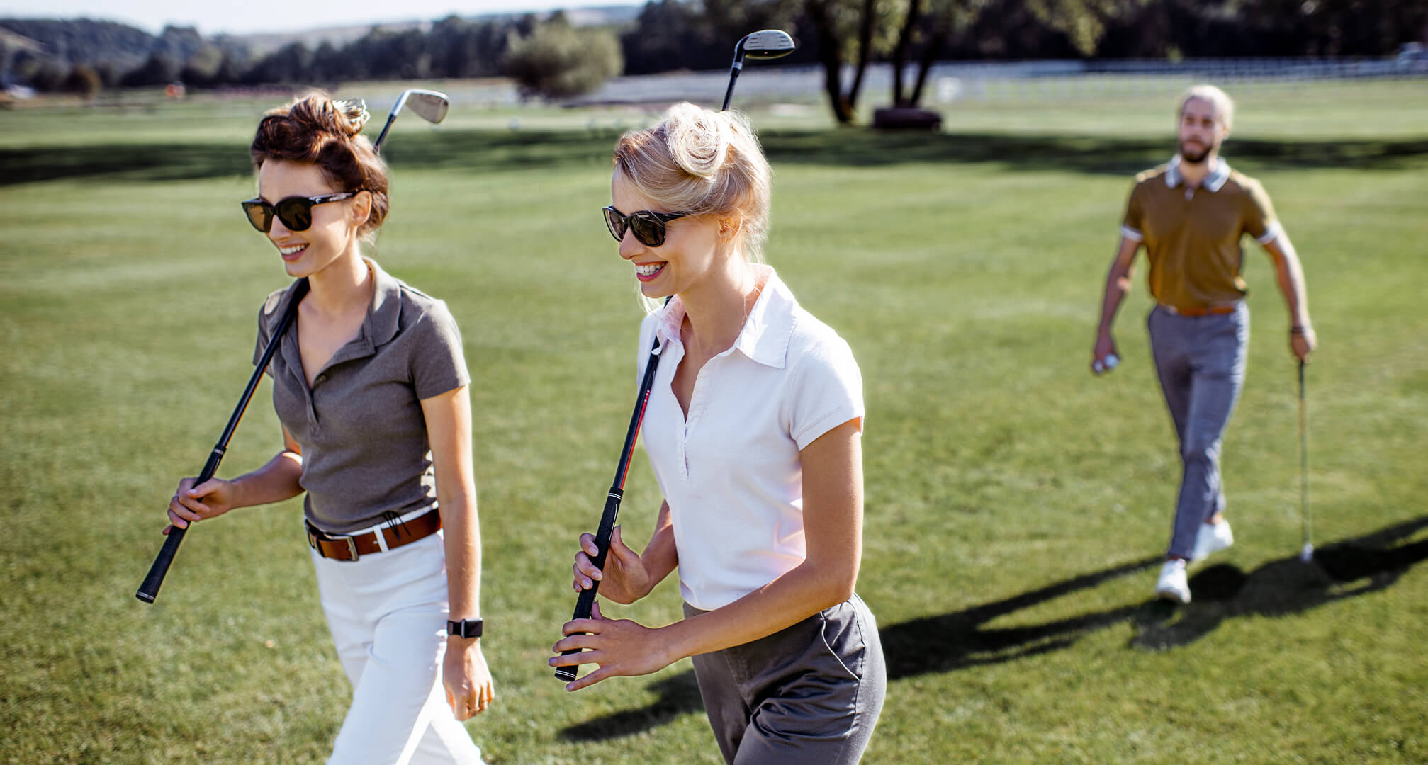 two people golfing with sunglasses