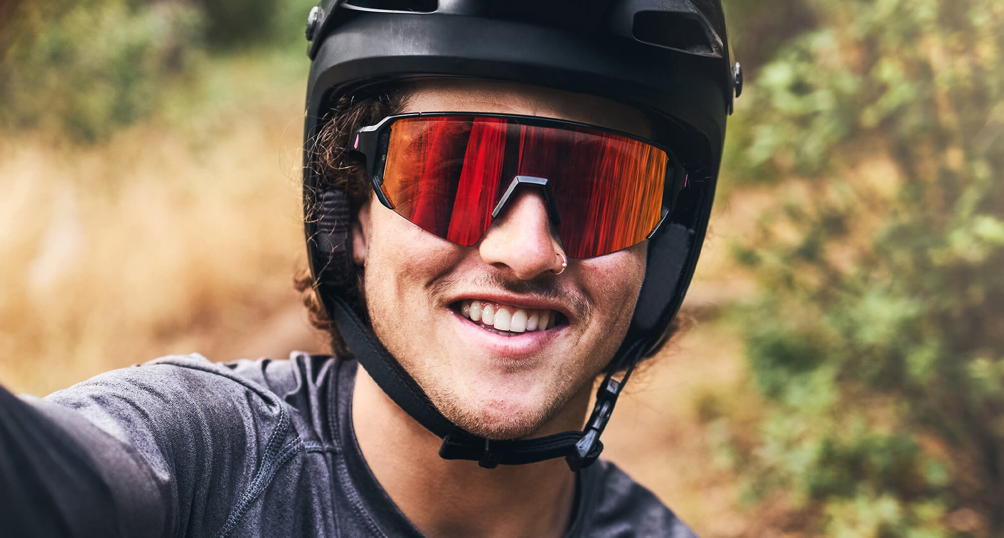 close up image of person wearing bike helmet and sunglasses